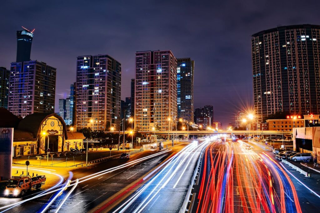Vibrant long exposure night cityscape in Beijing showcasing urban lights and skyscrapers.